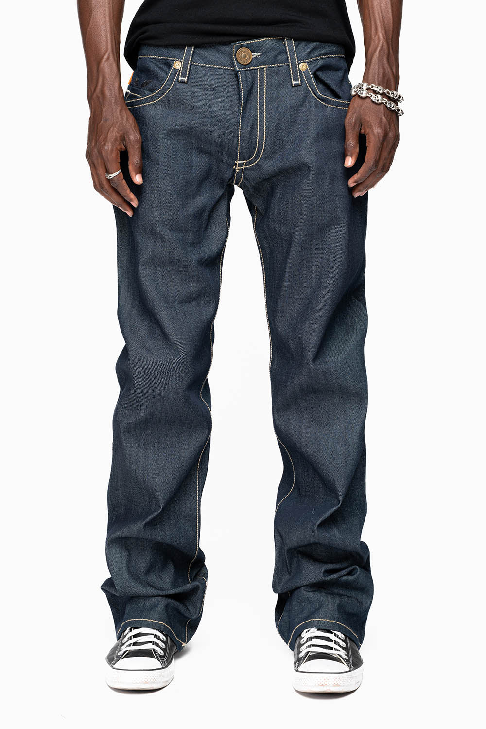 BOOT CUT JEAN  IN RAW DENIM WITH  GOLD LEATHER ZIPPER  EMBELLISHMENT ON BACK POCKETS