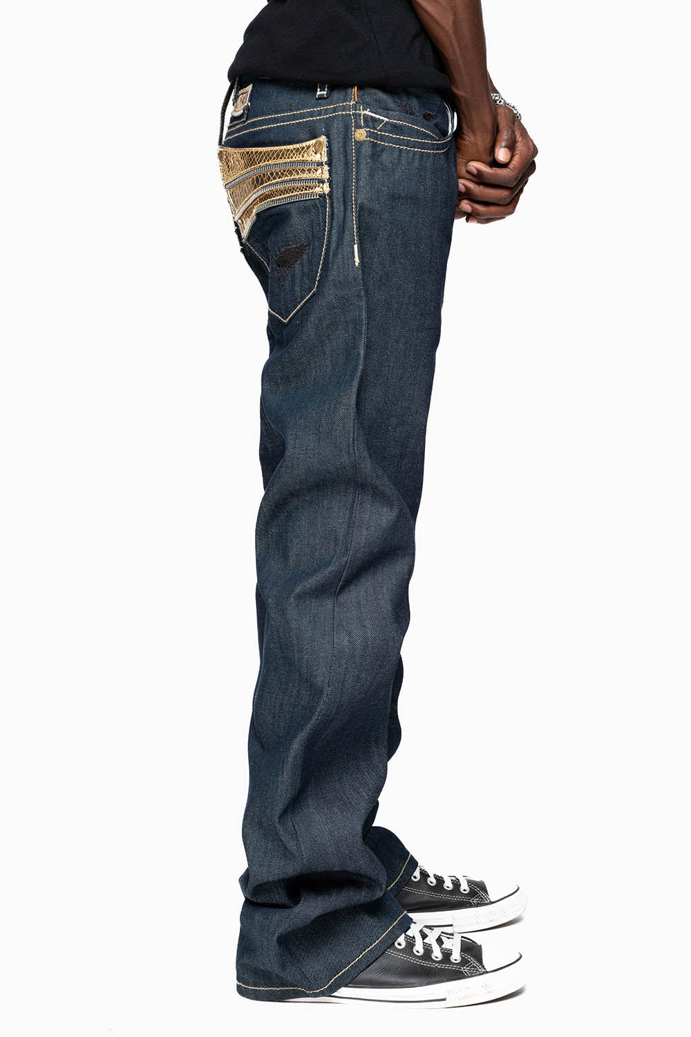 BOOT CUT JEAN  IN RAW DENIM WITH  GOLD LEATHER ZIPPER  EMBELLISHMENT ON BACK POCKETS