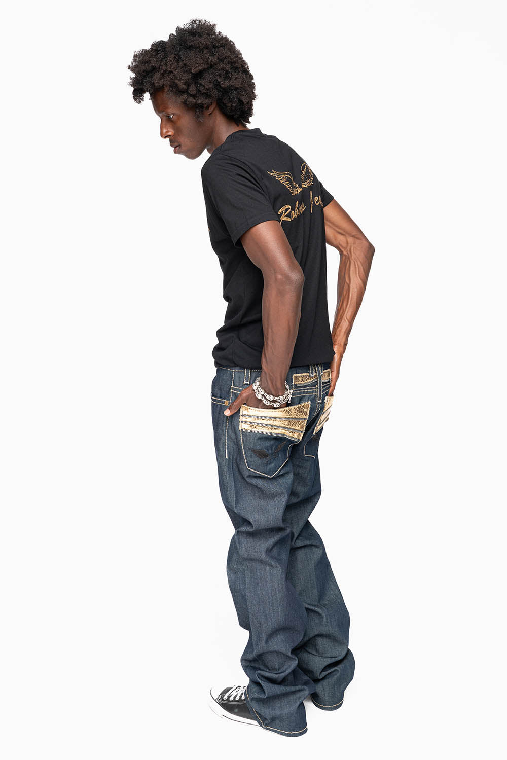 BOOT CUT JEAN  IN RAW DENIM WITH  GOLD LEATHER ZIPPER  EMBELLISHMENT ON BACK POCKETS