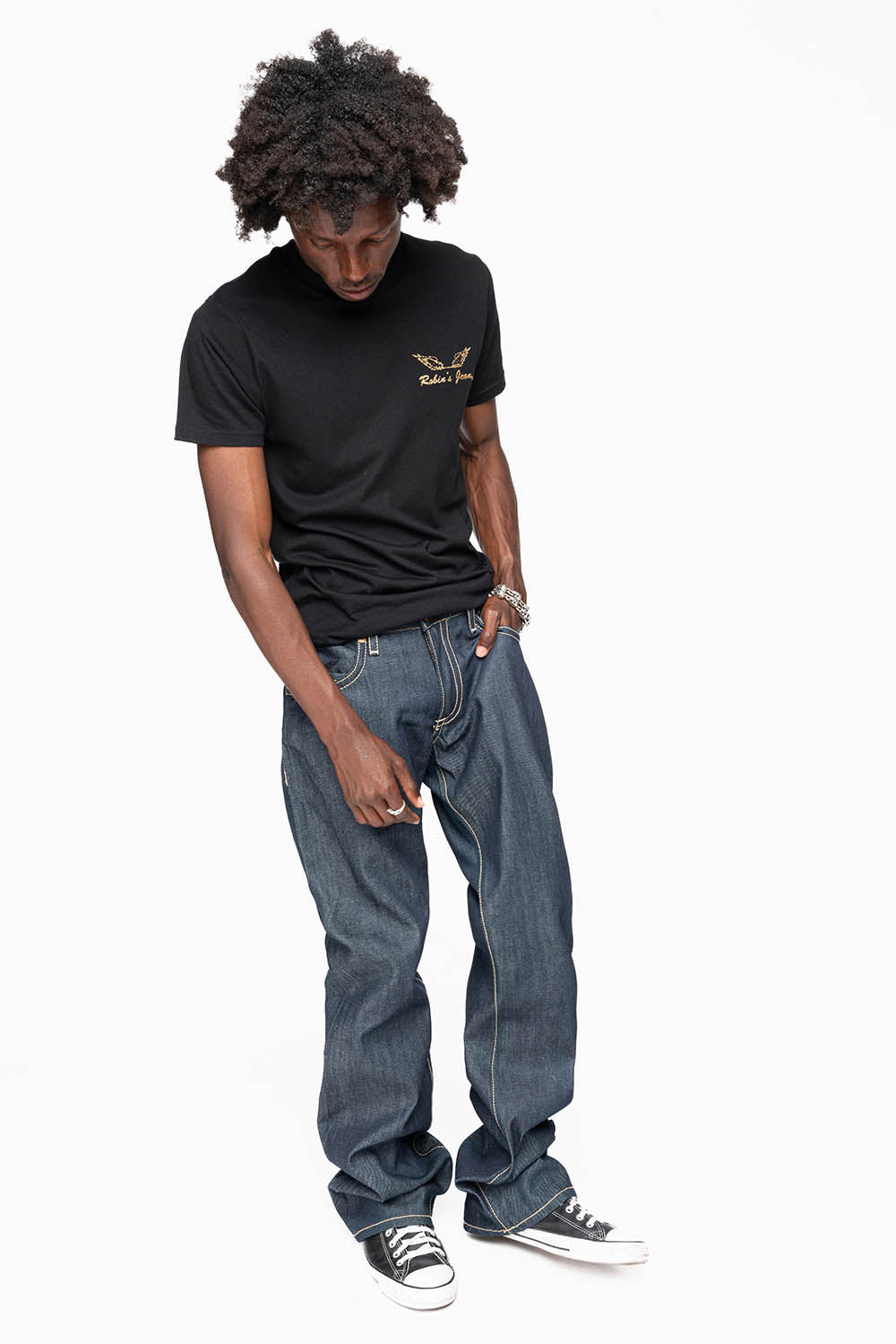 BOOT CUT JEAN  IN RAW DENIM WITH  GOLD LEATHER ZIPPER  EMBELLISHMENT ON BACK POCKETS