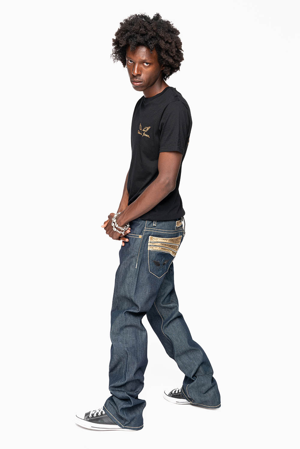 BOOT CUT JEAN  IN RAW DENIM WITH  GOLD LEATHER ZIPPER  EMBELLISHMENT ON BACK POCKETS