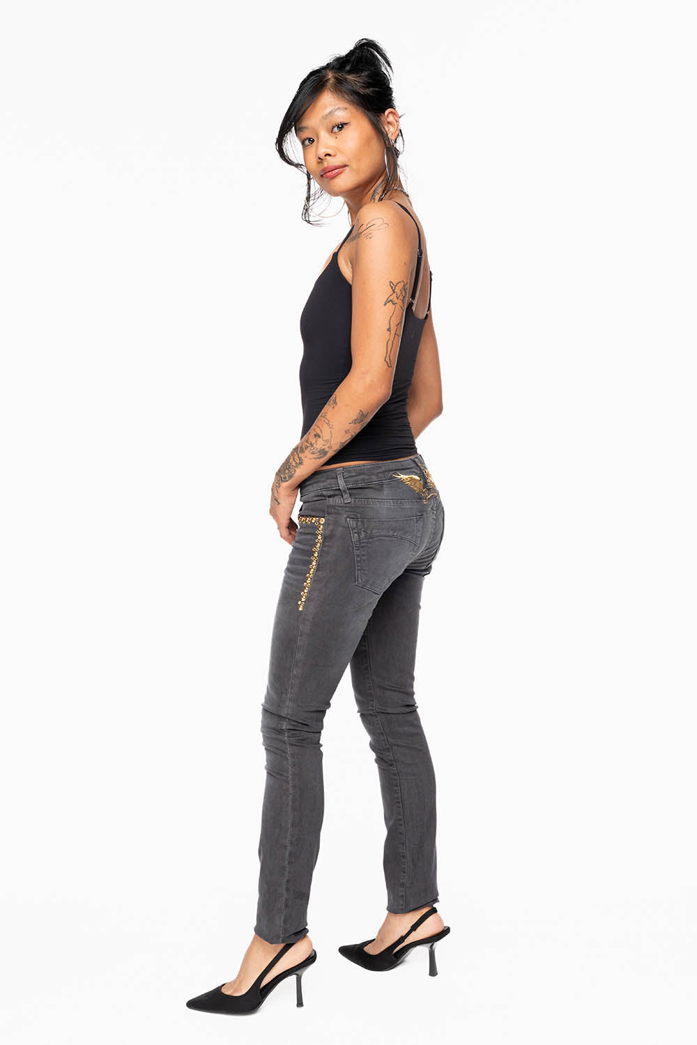 MARILYN WOMENS SKINNY JEANS IN PIGMENT SPRAY CHARCOAL WITH GOLD WINGS EMBELLISHED WITH CRYSTALS & STUDS