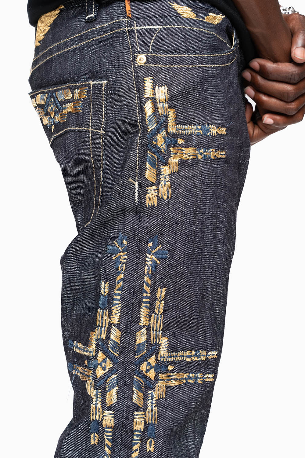 ROBIN’S MEN  SLIM JEAN IN CHAPA GOLD INDIGO RAW DENIM WITH GOLD WING AND CHAPA EMBROIDERY