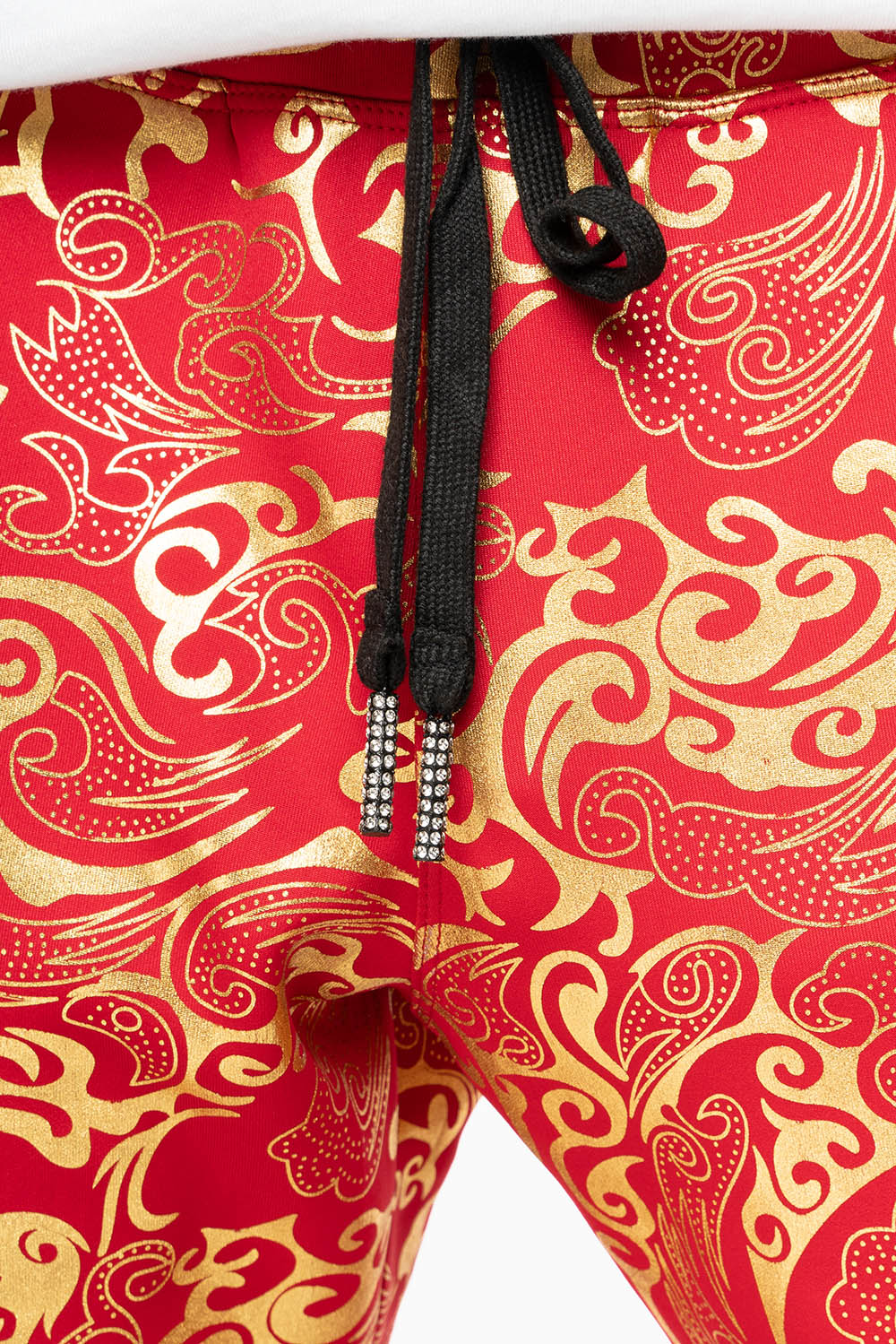 CLOUD JOGGER IN GOLD/RED PRINT EMBELLISHED WITH LARGE CRYSTALS