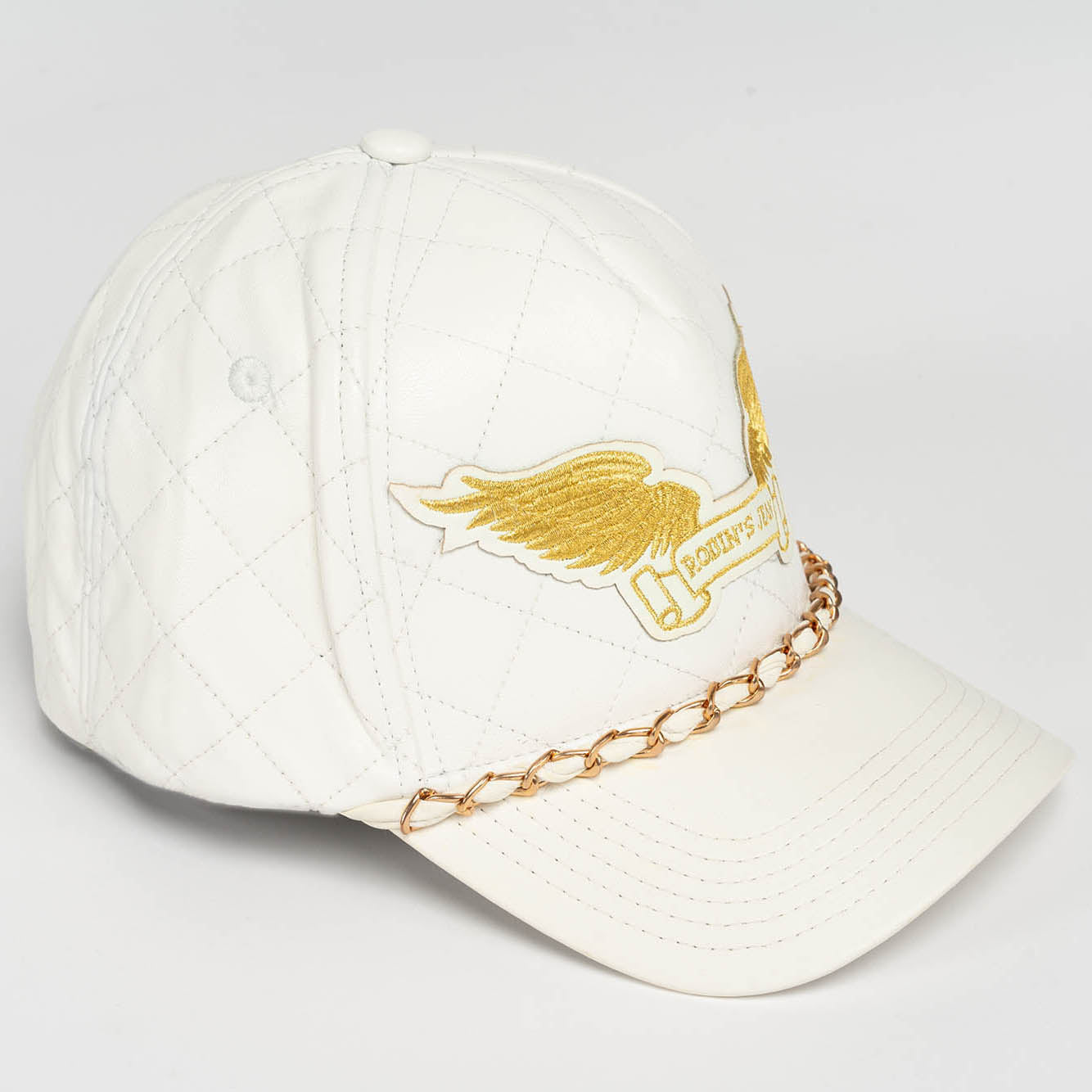 ROBINS LEATHER QUILTED CAP WITH GOLD WINGS STUDS AND COPPER CHAIN IN WHITE